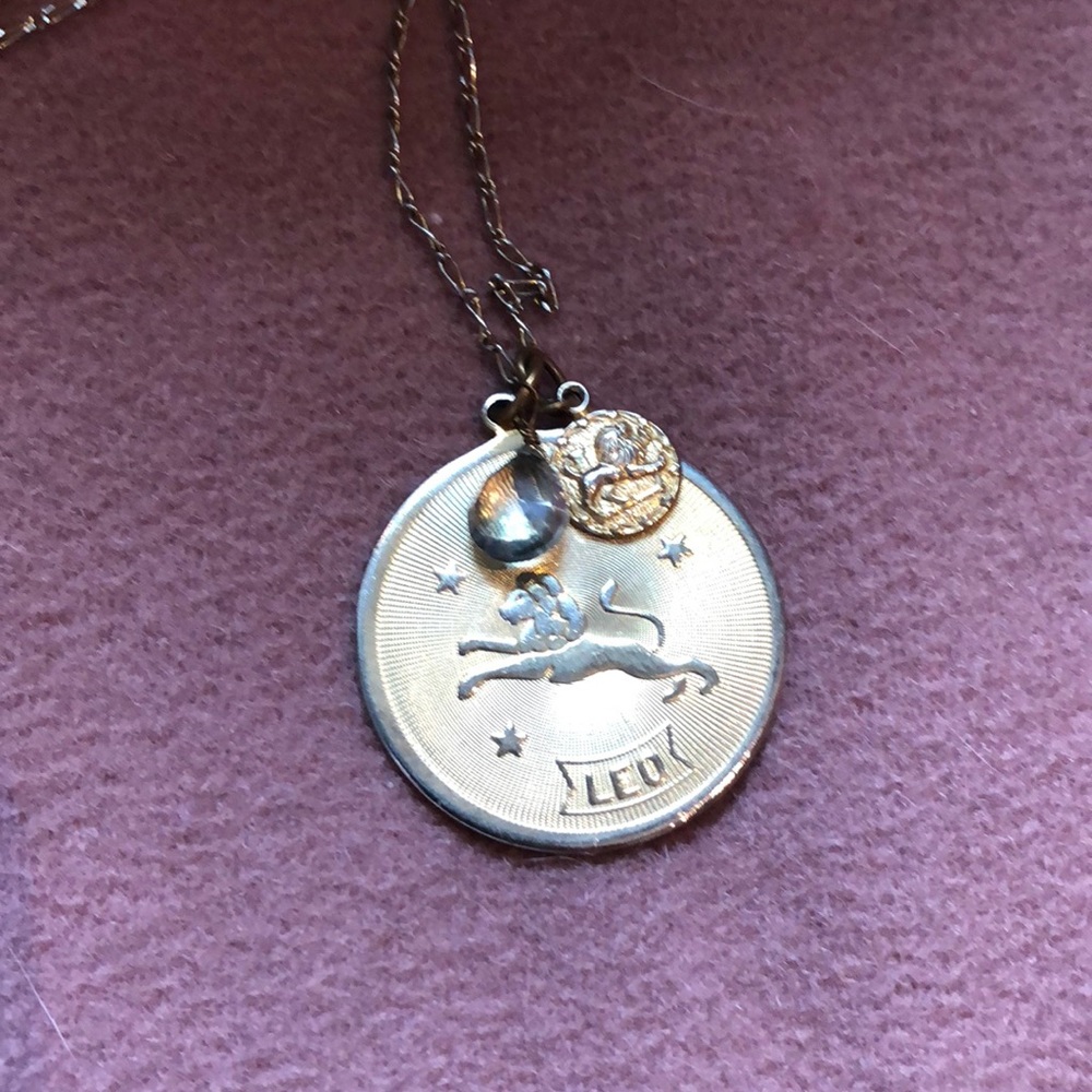 Gold Leo pendant on a delicate chain